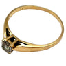 Gold ring with a diamond on a white background