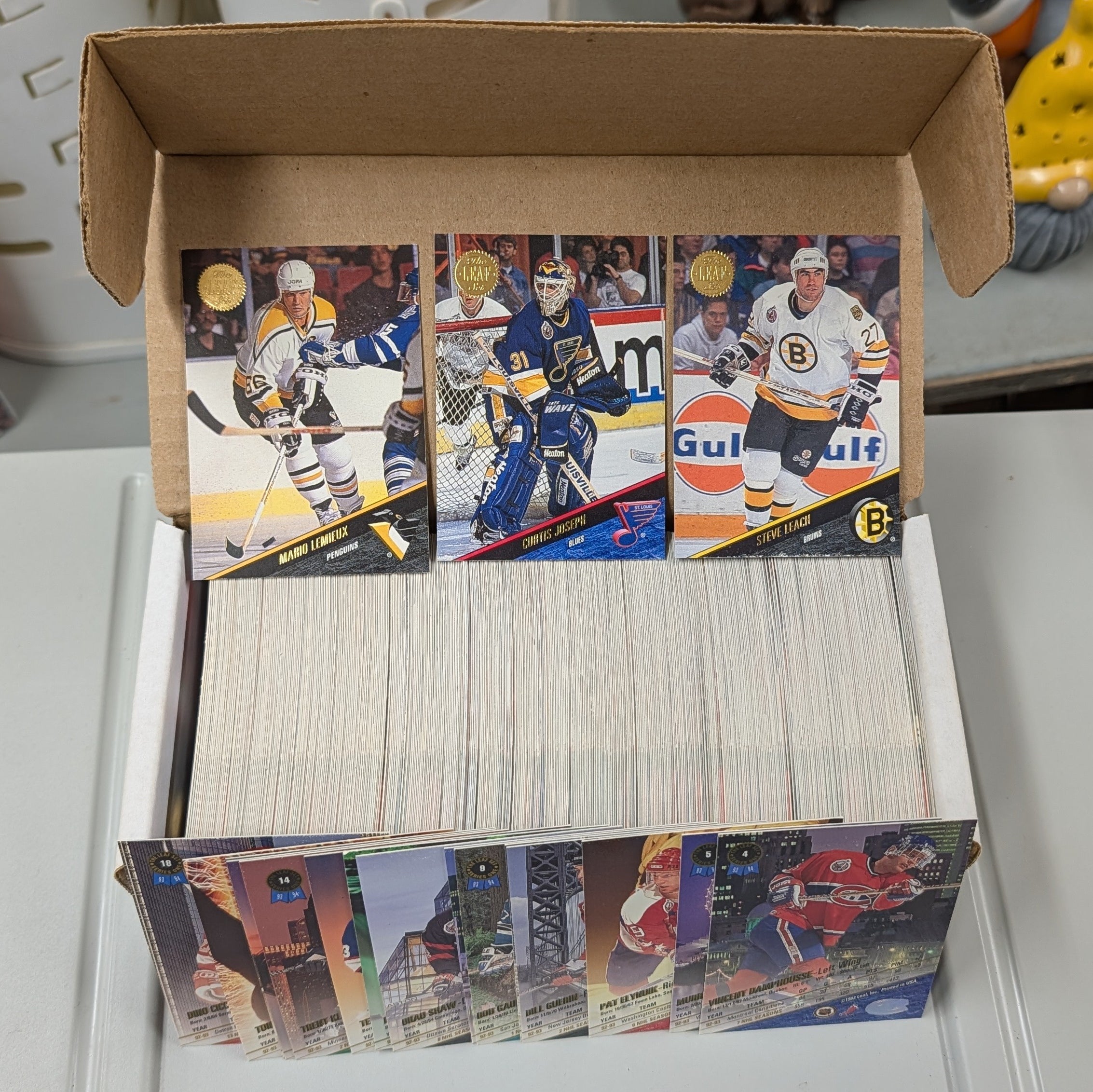 Collection of hockey cards in a box on a white surface