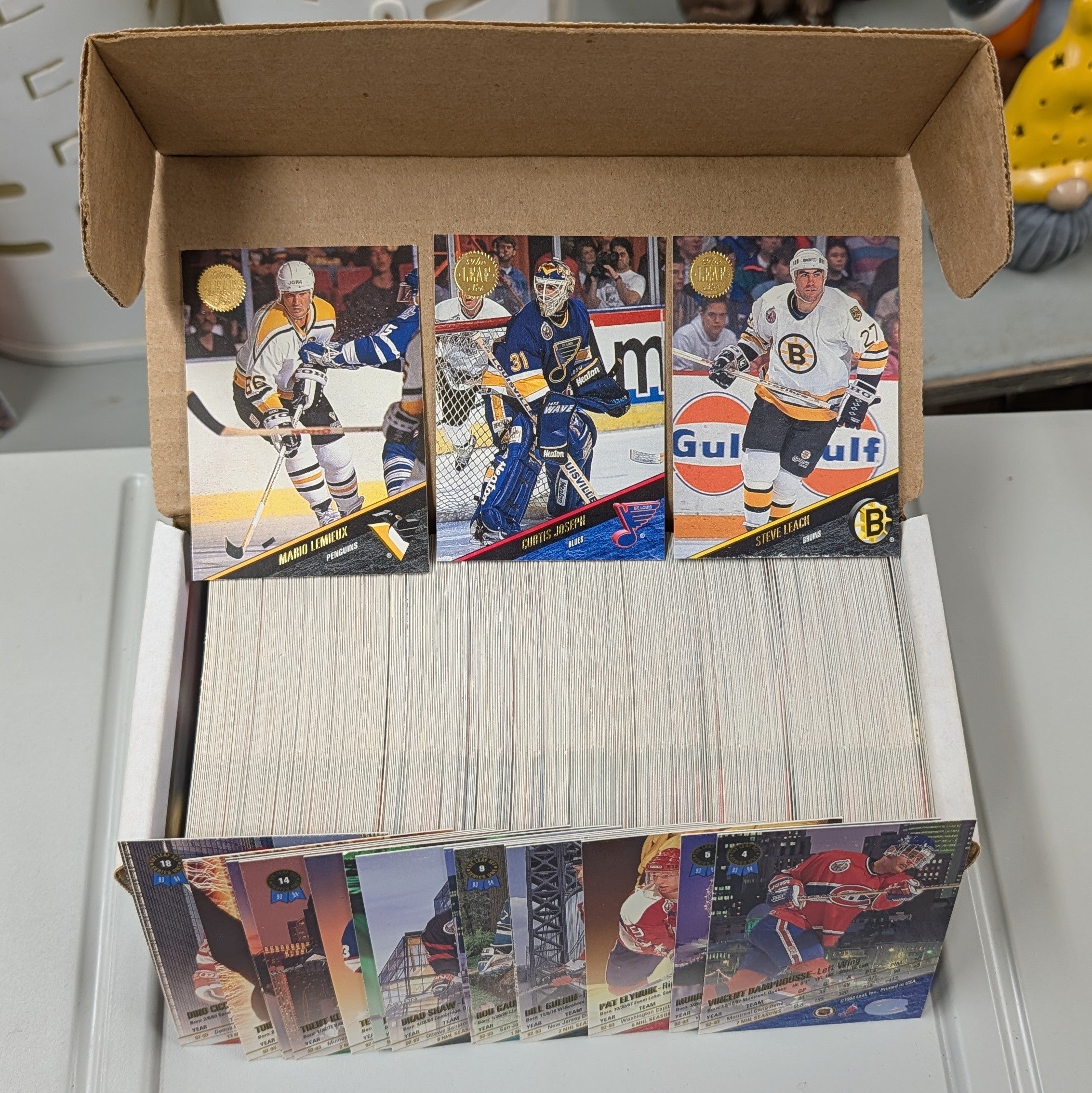 Collection of hockey cards in a box on a white surface
