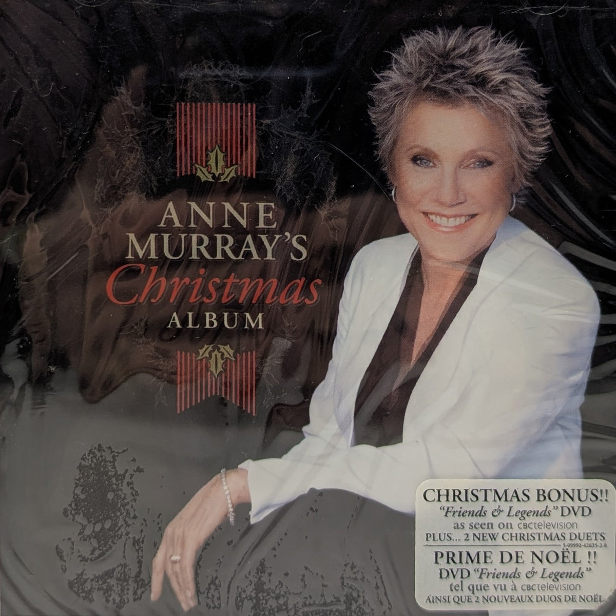 Anne Murray's Christmas Album 2-disc CD in its clear plastic jewel case, featuring a portrait of the artist in a white blazer against a dark background with red and gold decorative elements.