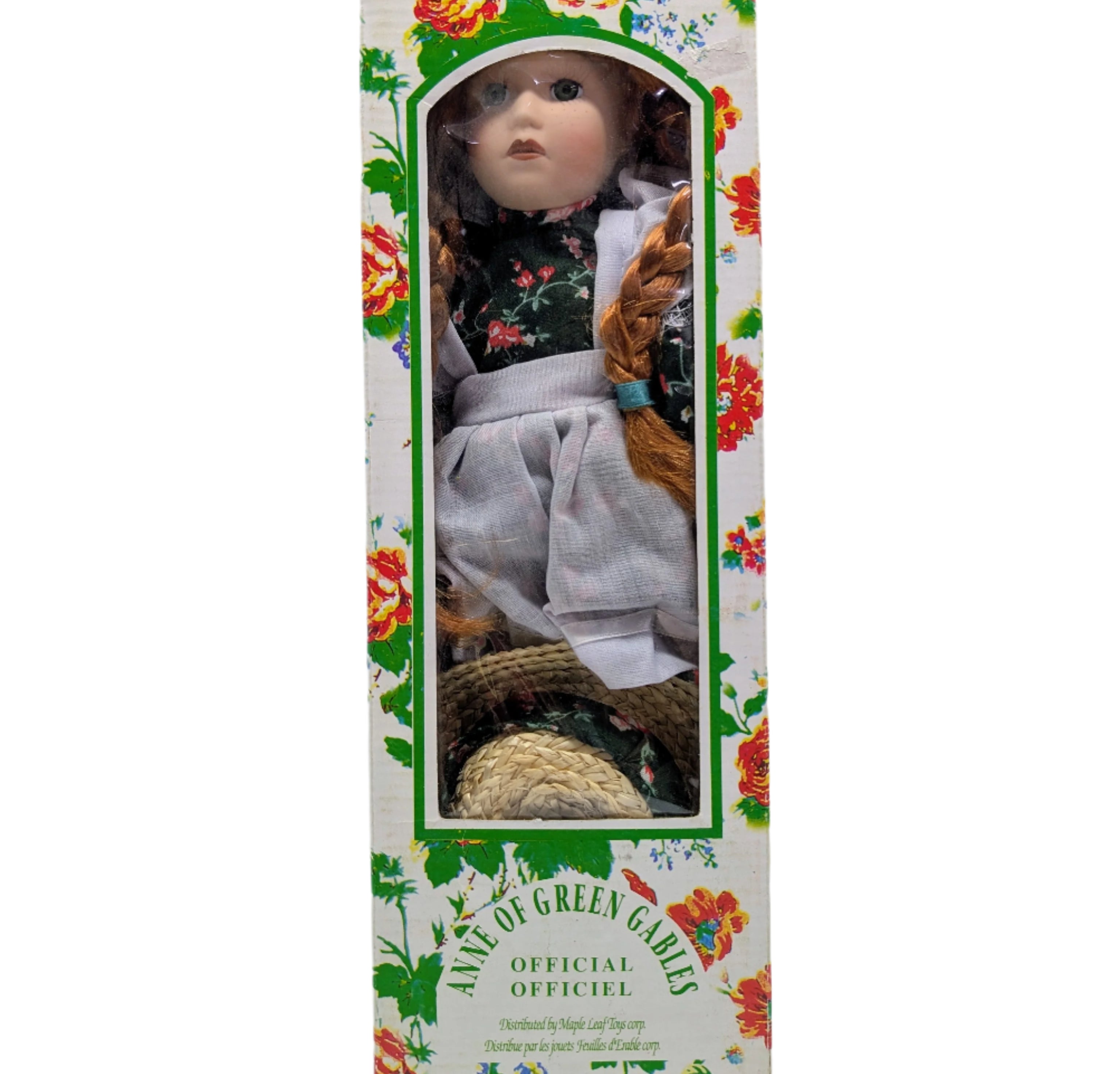 Doll in a decorative box with floral patterns on a white background