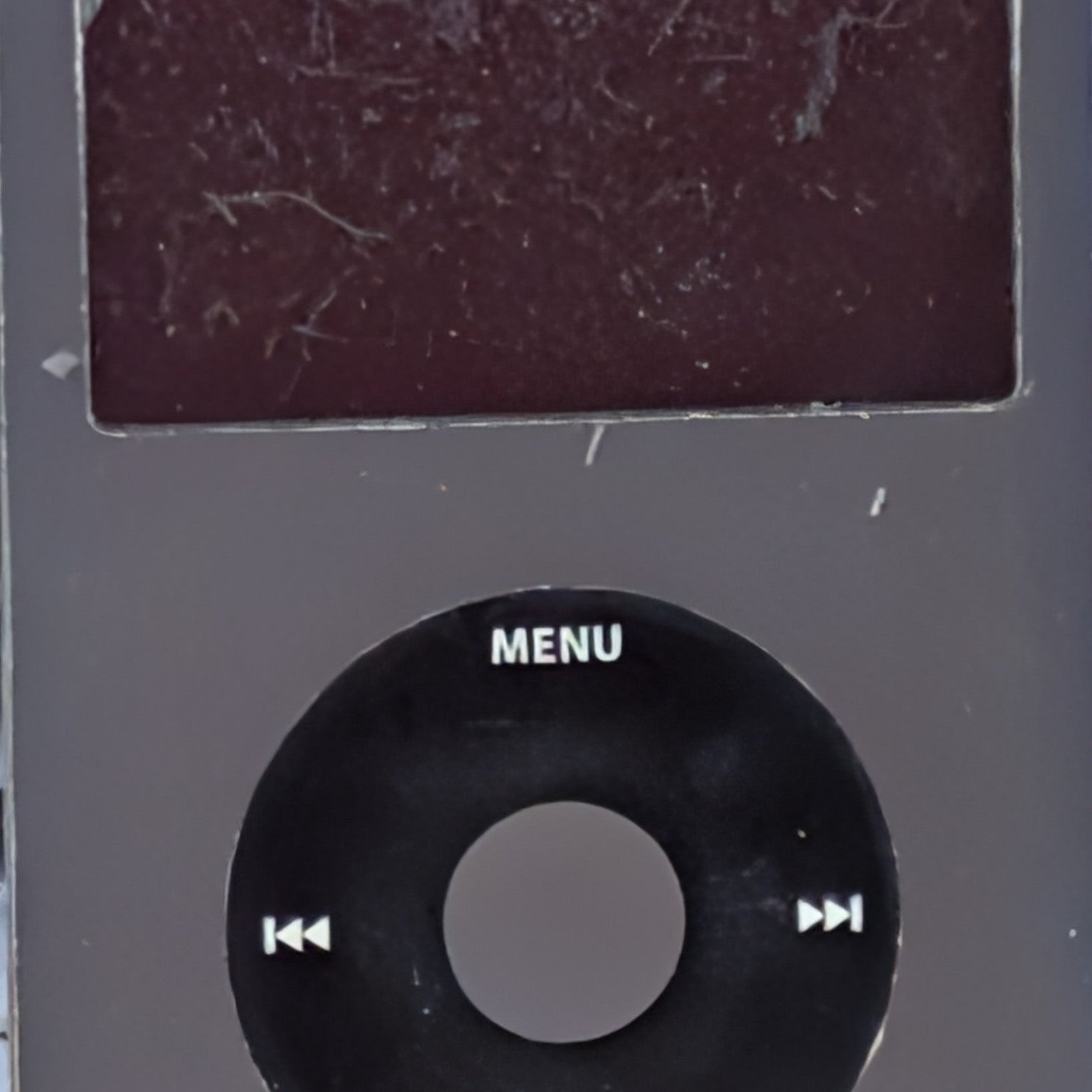 A used black Apple iPod Classic portable player with a scratched screen
