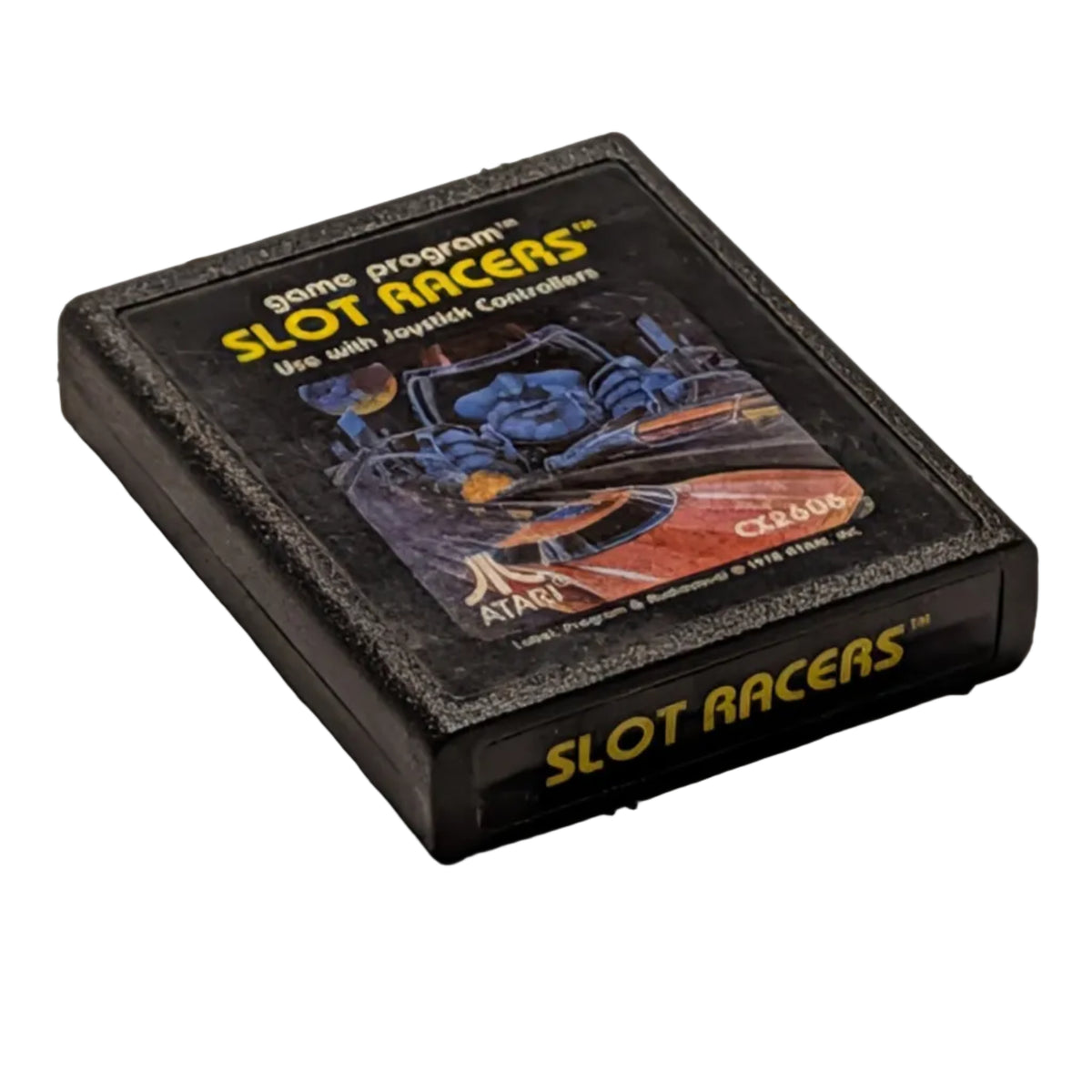 A vintage Atari video game cartridge for Slot Racers resting on a white surface.