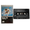 A Boney M Christmas Album cassette tape shown next to its original plastic jewel case on a plain light background. The cassette is black with silver details, and the sleeve features a blue winter-themed design with the band's name and album title.