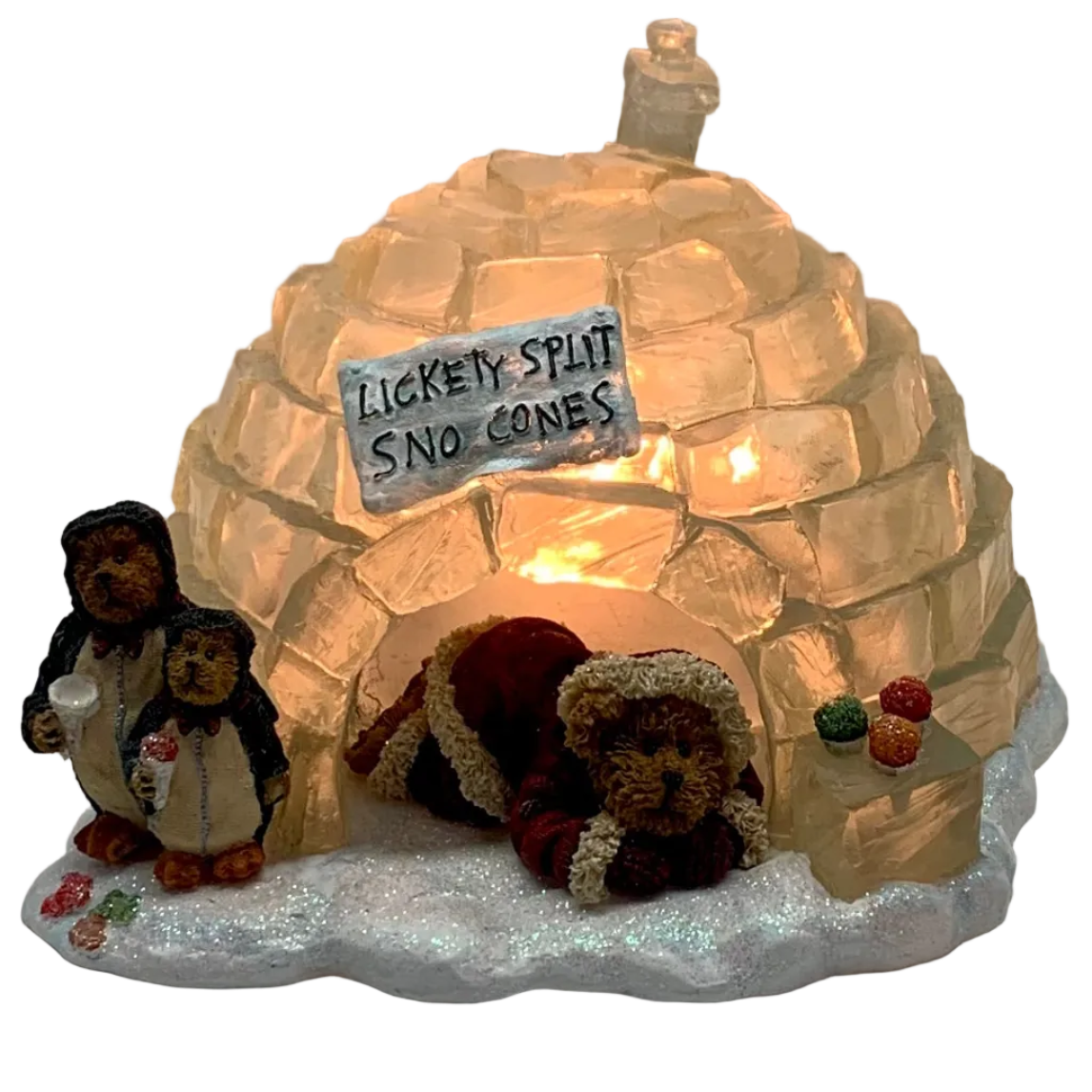 An illuminated desk lamp featuring a bear-themed design with an igloo structure, ticket stubs, and snowflakes.