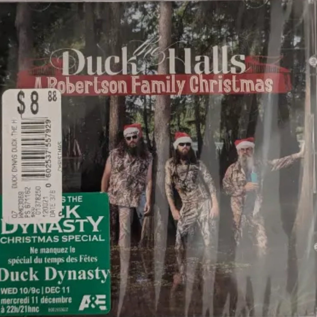 A CD case for the Duck the Halls A Robertson Family Christmas by Duck Dynasty. The CD cover features the band members in a dark forest scene.