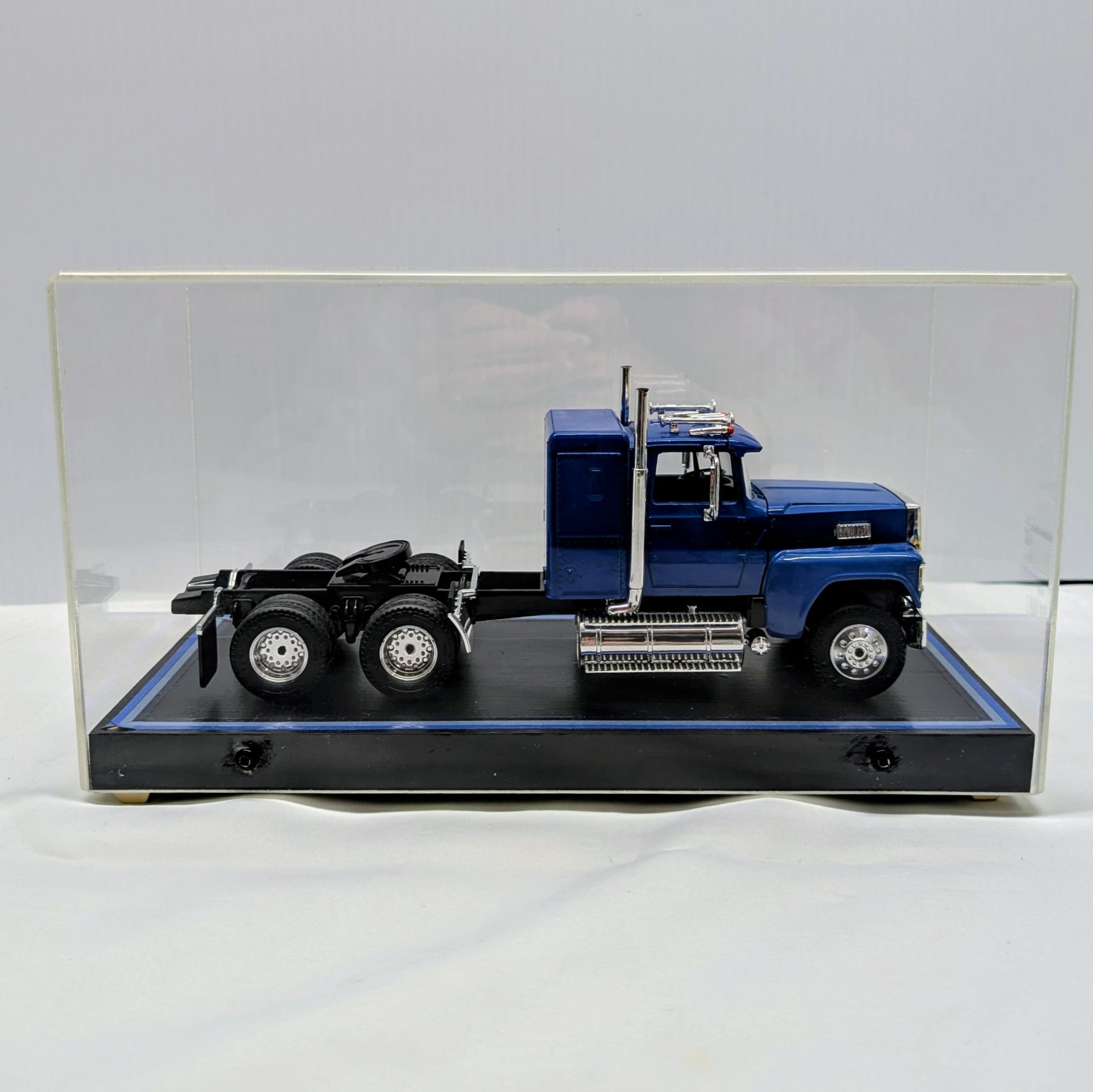Model truck in a clear display case on a white background
