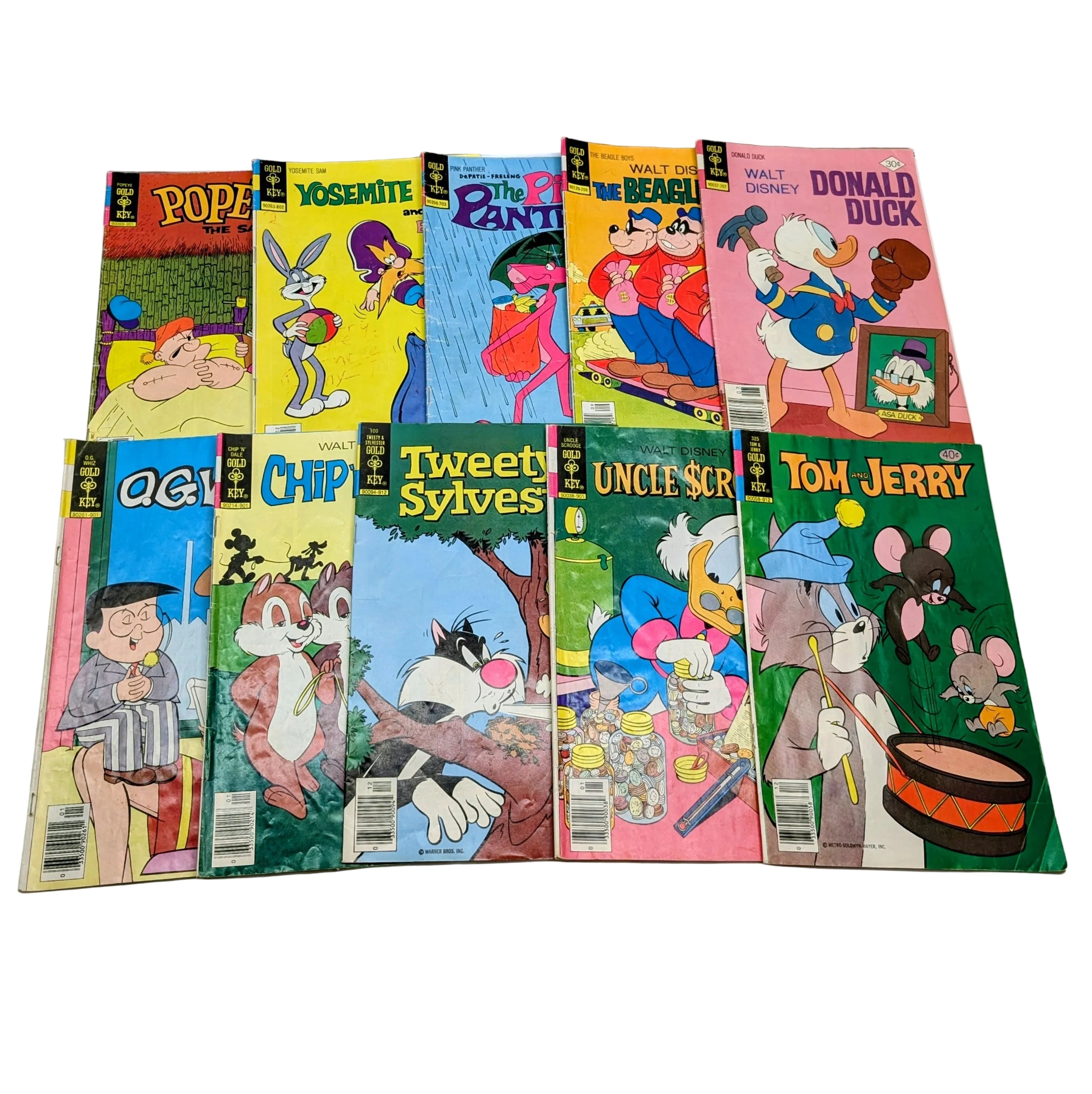Collection of vintage comic books featuring various cartoon characters on a white background.