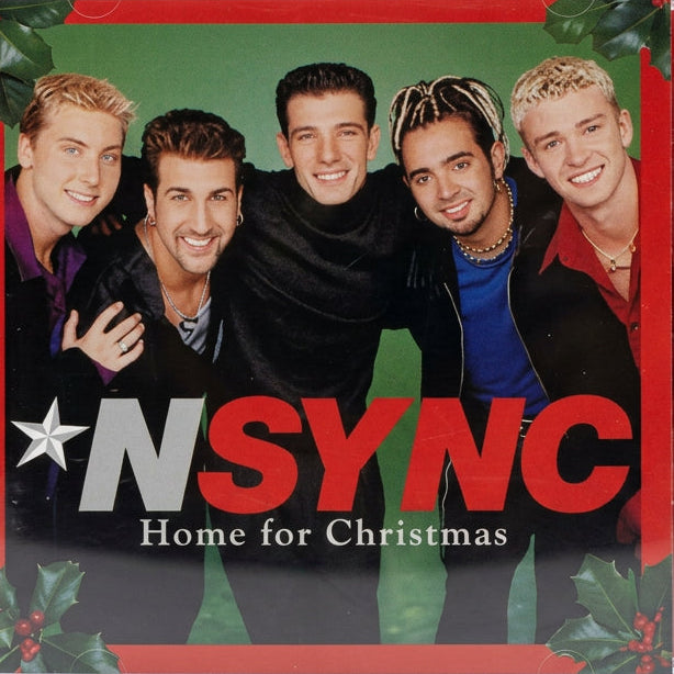 NSYNC 'Home for Christmas' CD album cover displayed on a textured light gray surface with a red painted mark on the right side.