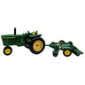 Model green tractor with a plow on a white background
