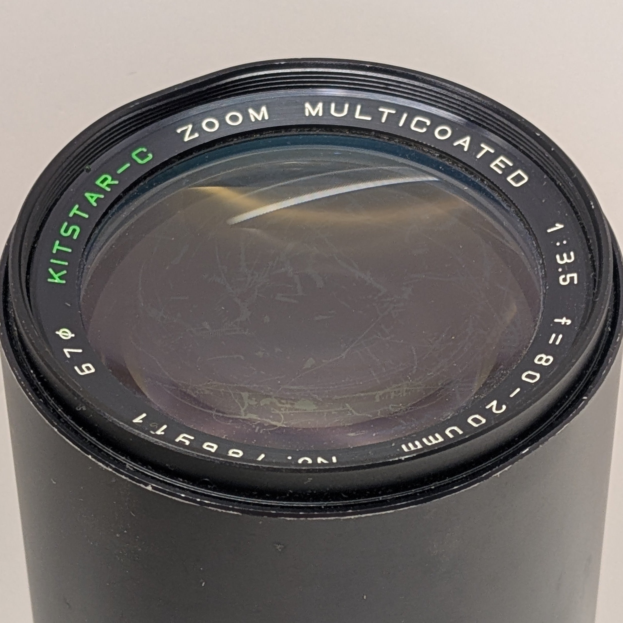 Multicoated camera lens with specifications on a wh background