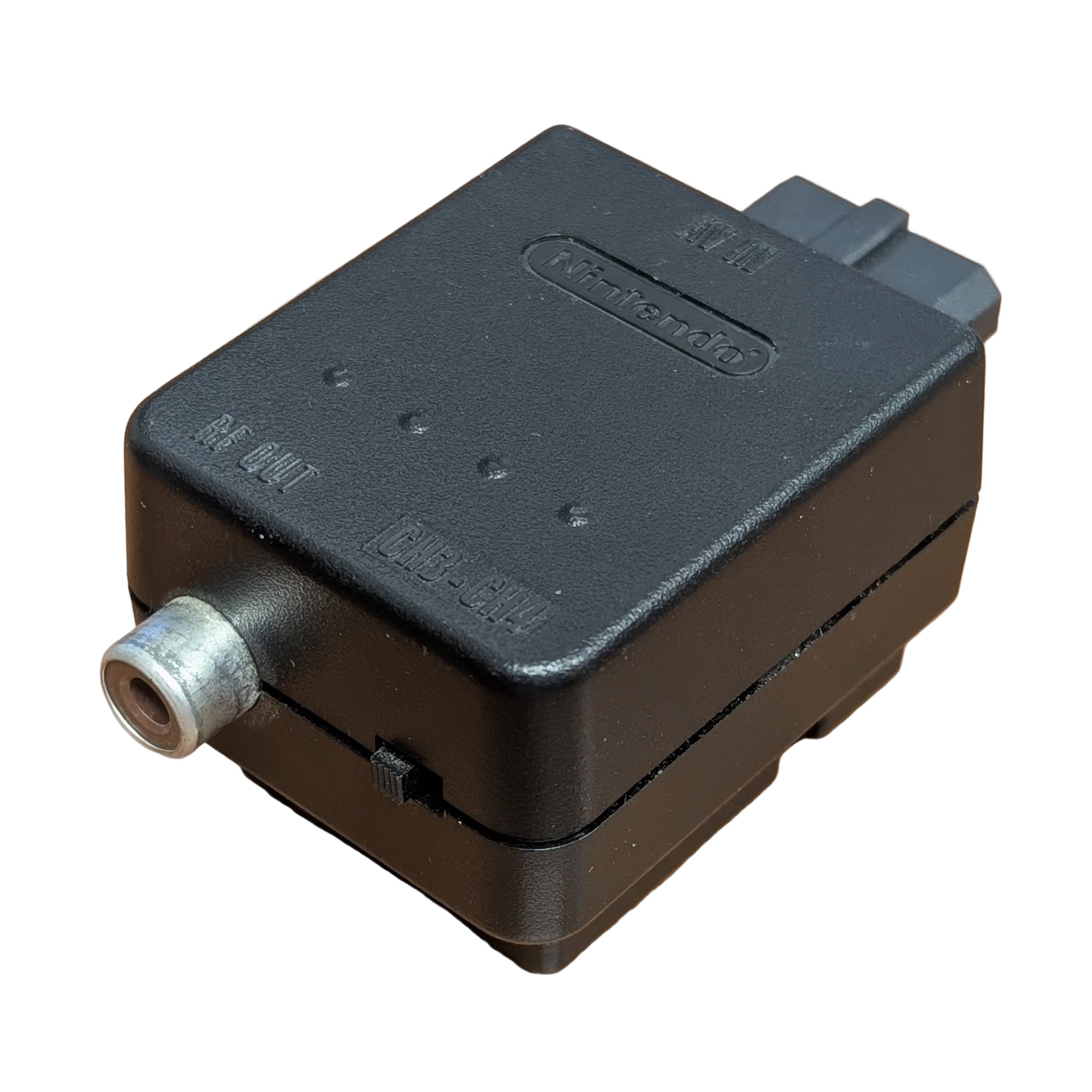 Black electronic module with a cylindrical connector on a whitesurface