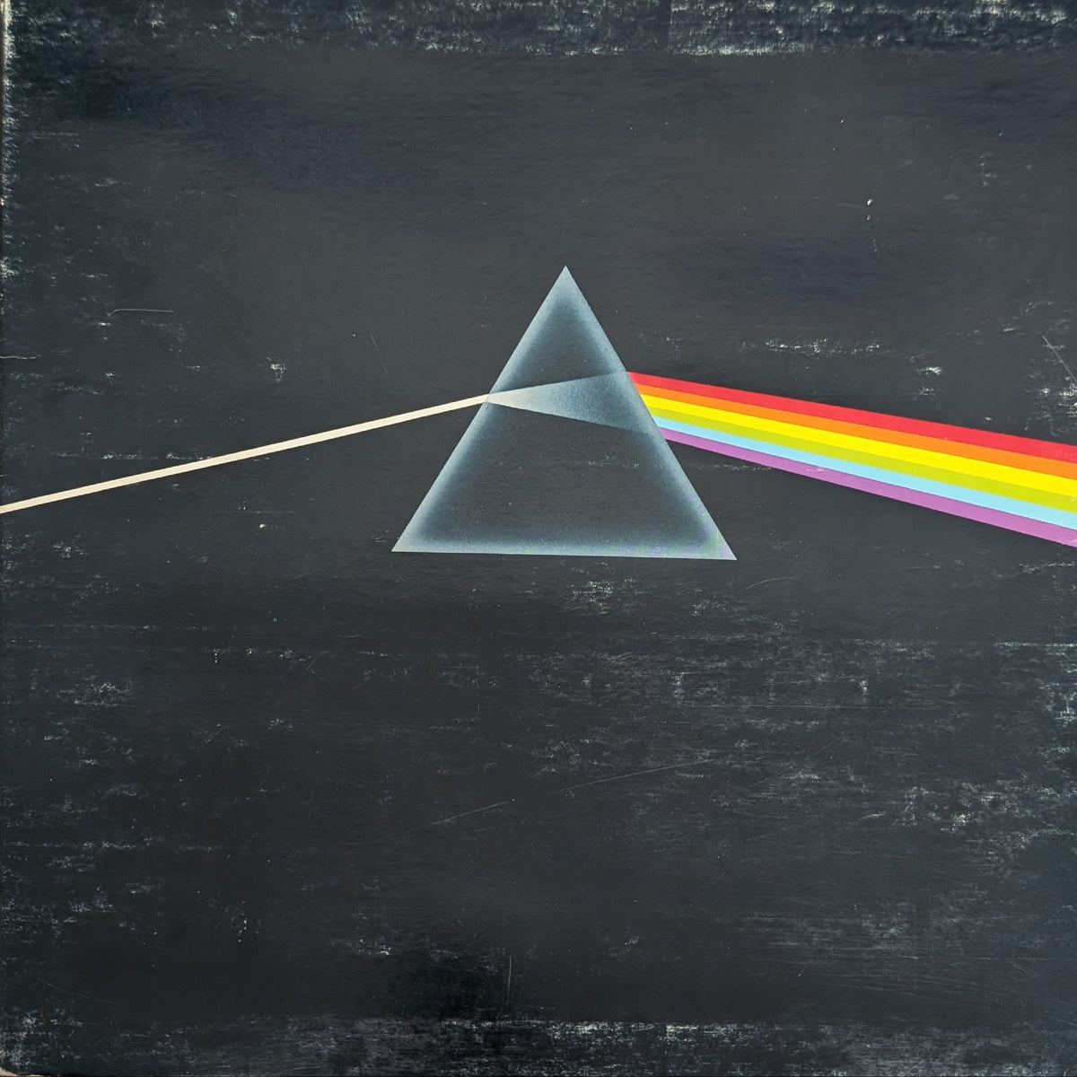 Pink Floyd 'The Dark Side of the Moon' vinyl record album cover, showing the classic prism graphic on a textured black background.
