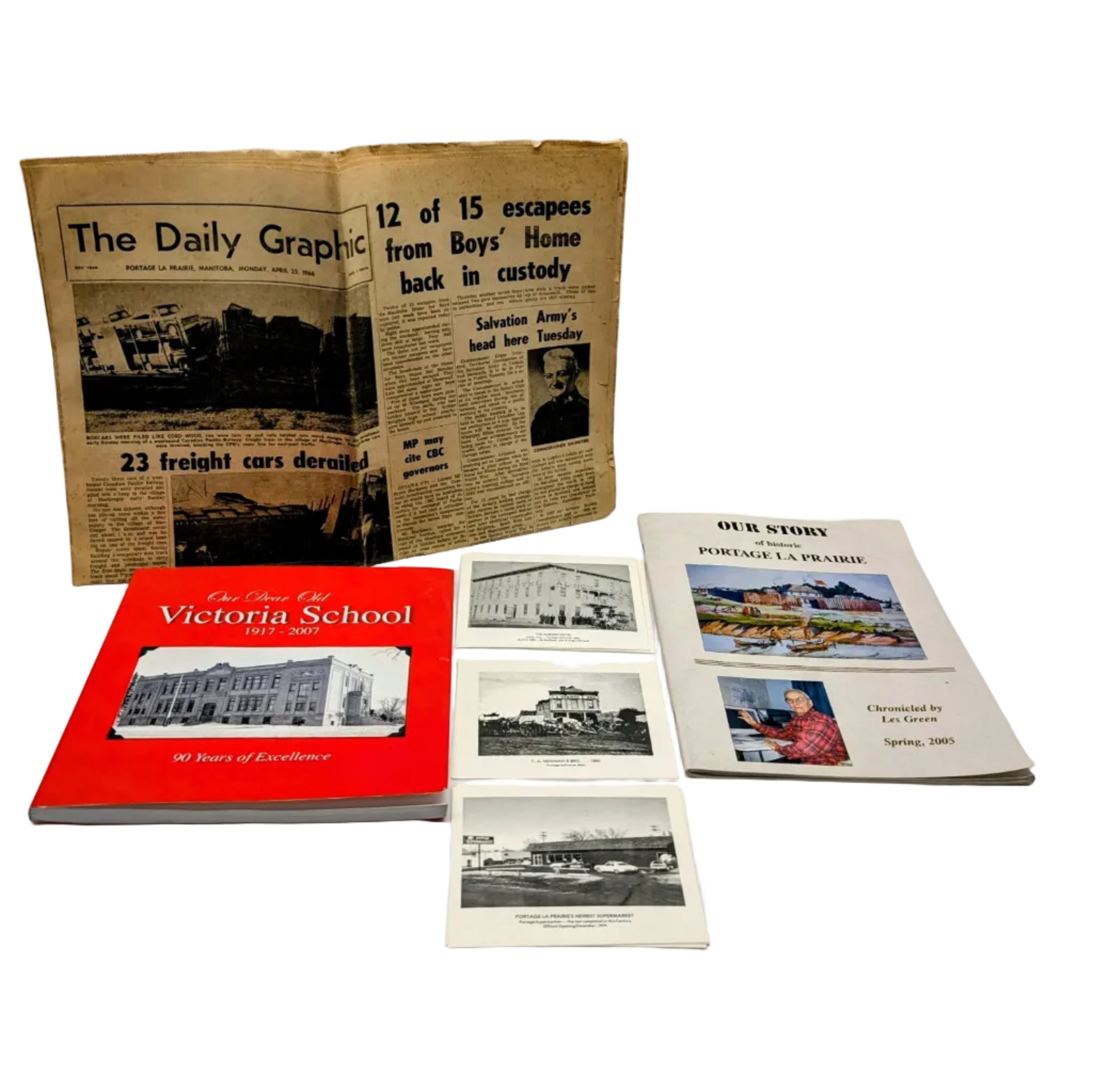 Collection of vintage books and newspapers on a white surface