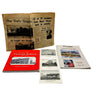 Collection of vintage books and newspapers on a white surface