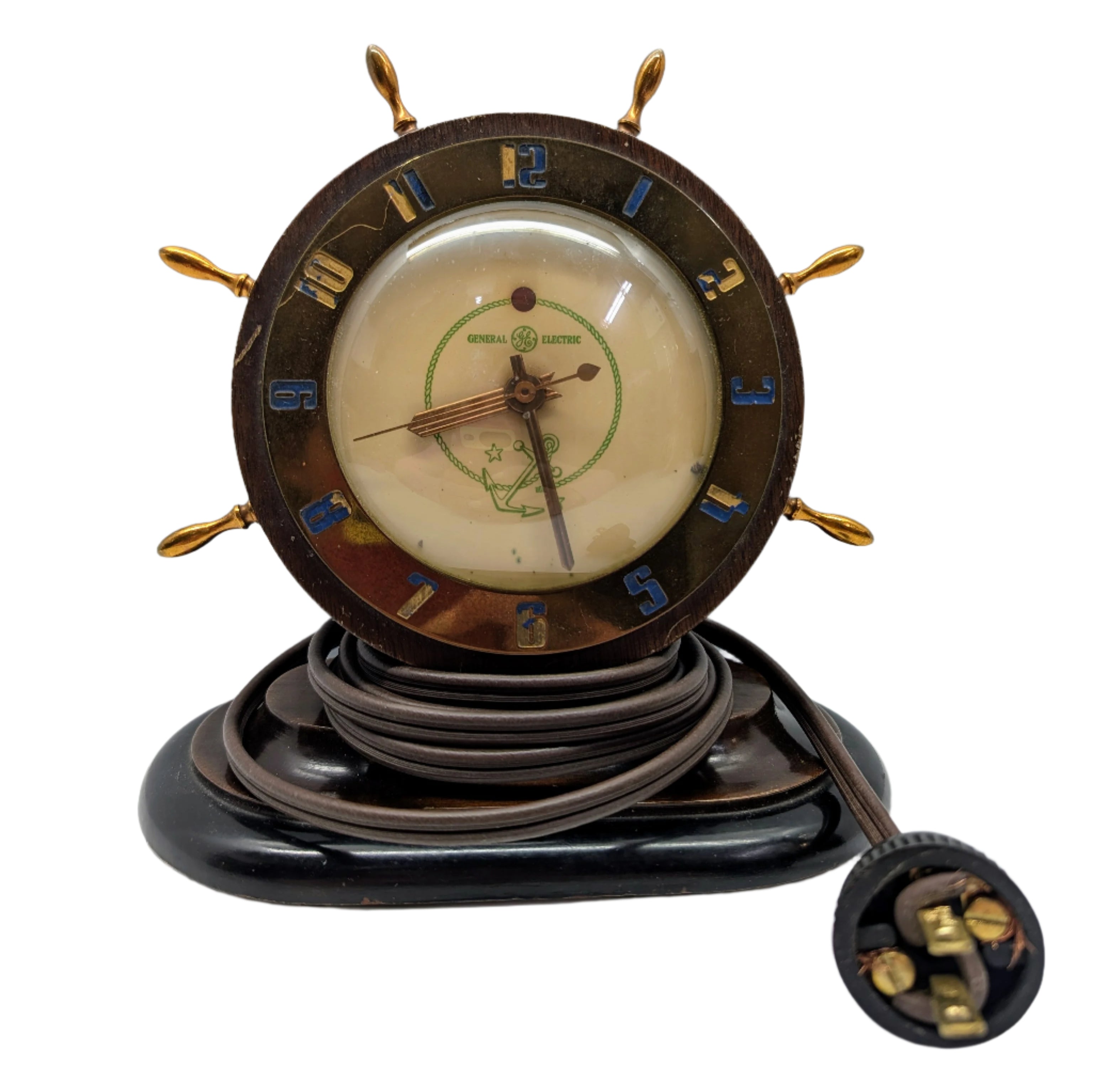 Vintage clock with steering wheel design on a white background