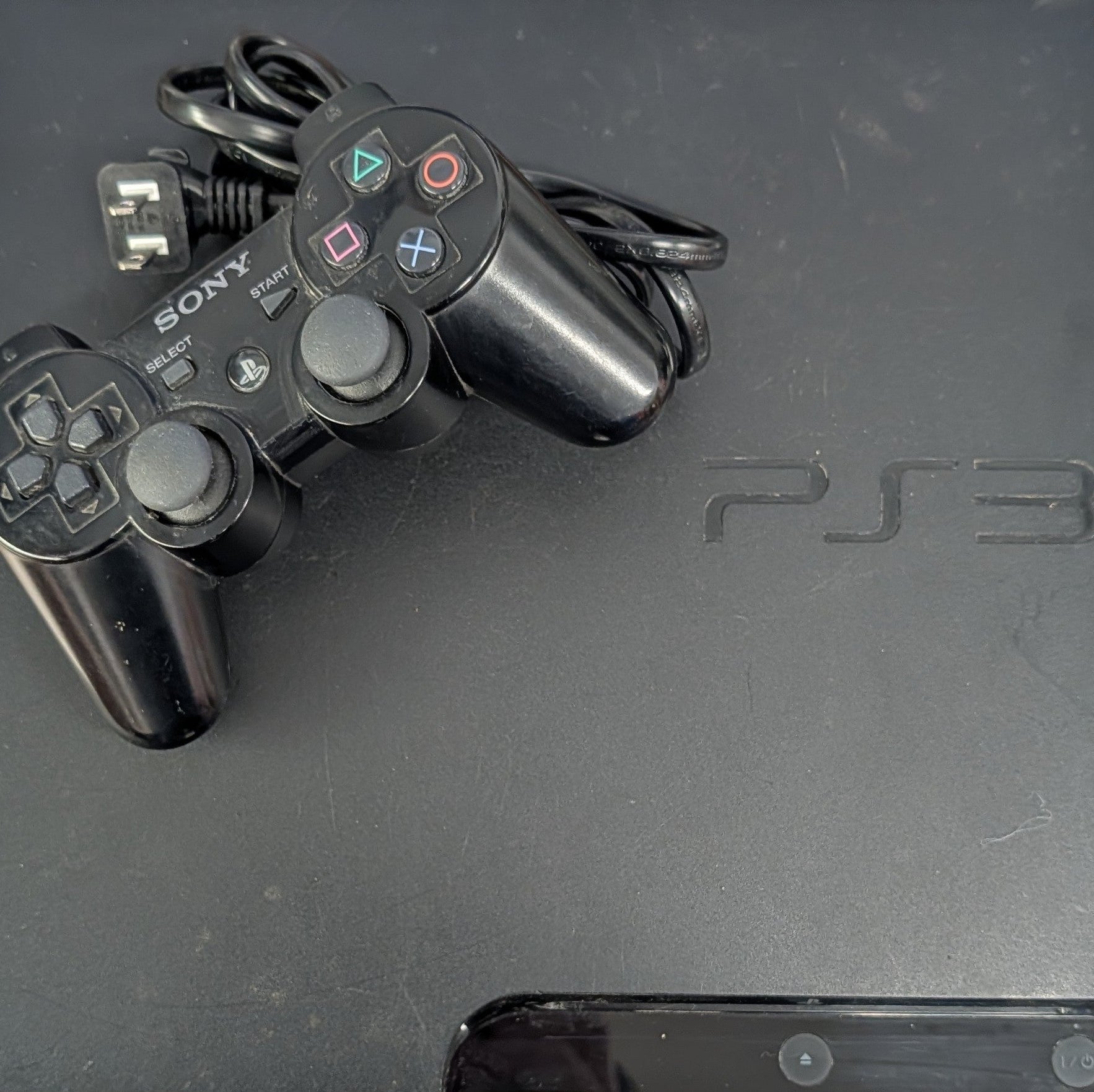 PlayStation 3 console with one controller and power cord