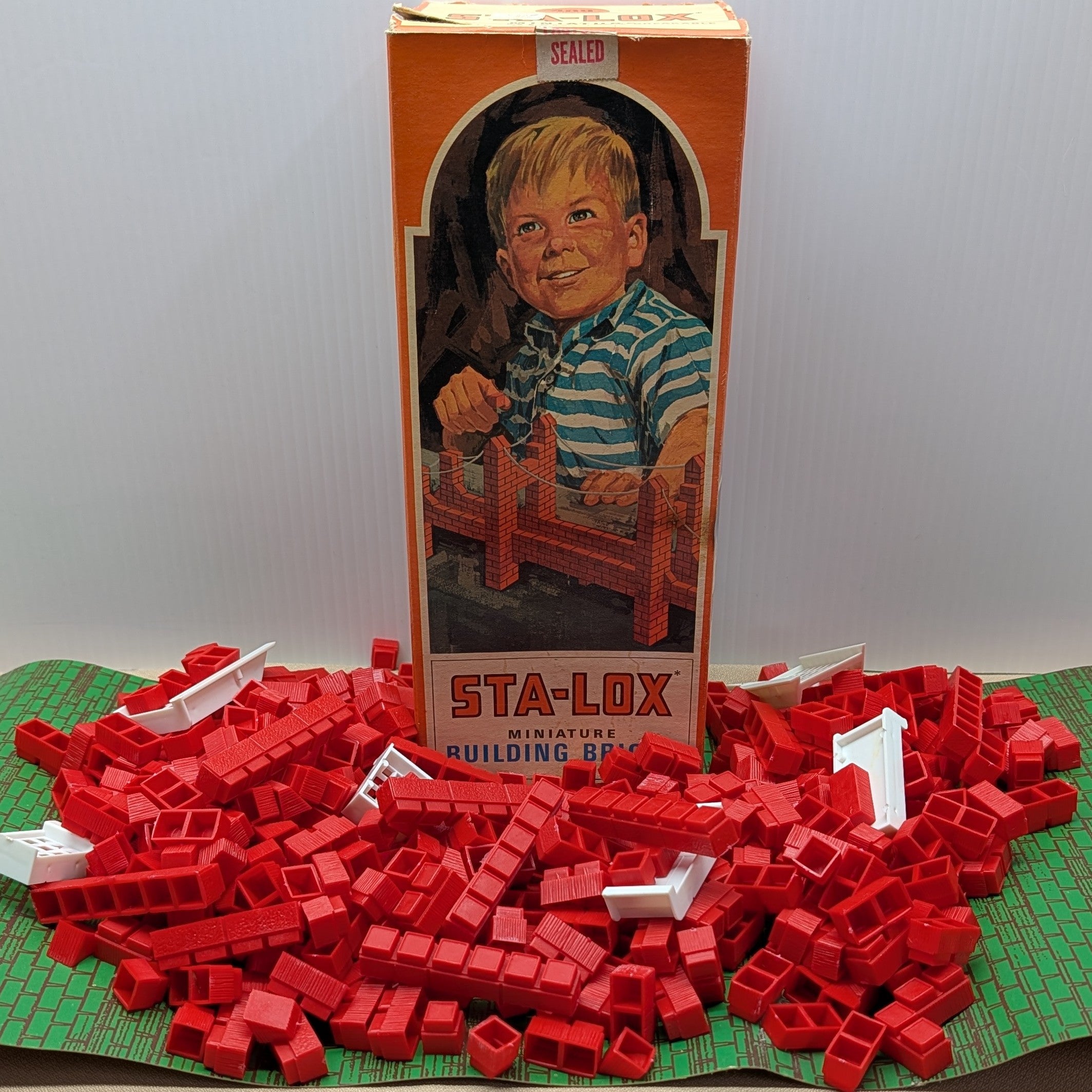 Vintage Sta-Lox building blocks with packaging featuring a child