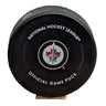 A black National Hockey League official game puck with the Winnipeg Jets logo in the center.