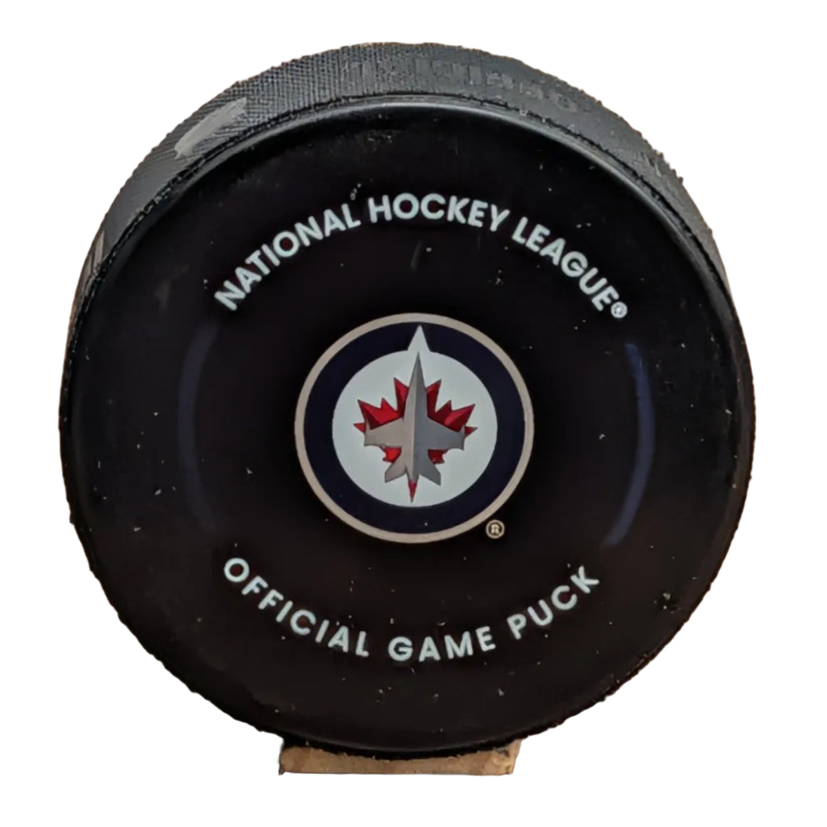 A black National Hockey League official game puck with the Winnipeg Jets logo in the center.