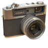 A vintage Yashica Minimatic-C SLR camera with a silver and black textured body.