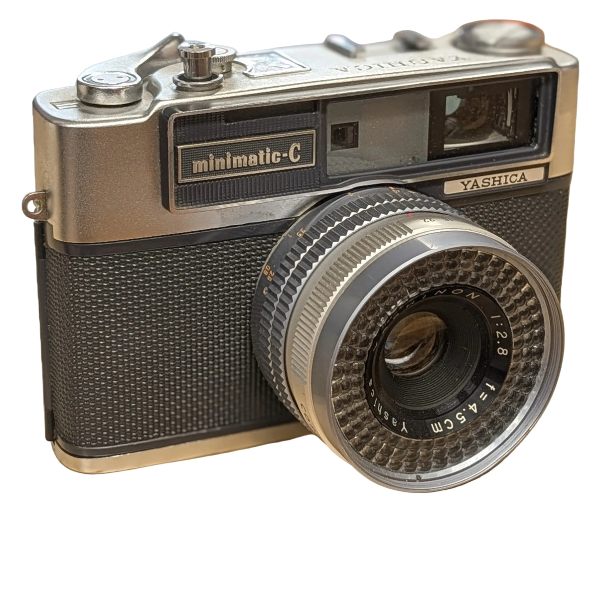 A vintage Yashica Minimatic-C SLR camera with a silver and black textured body.