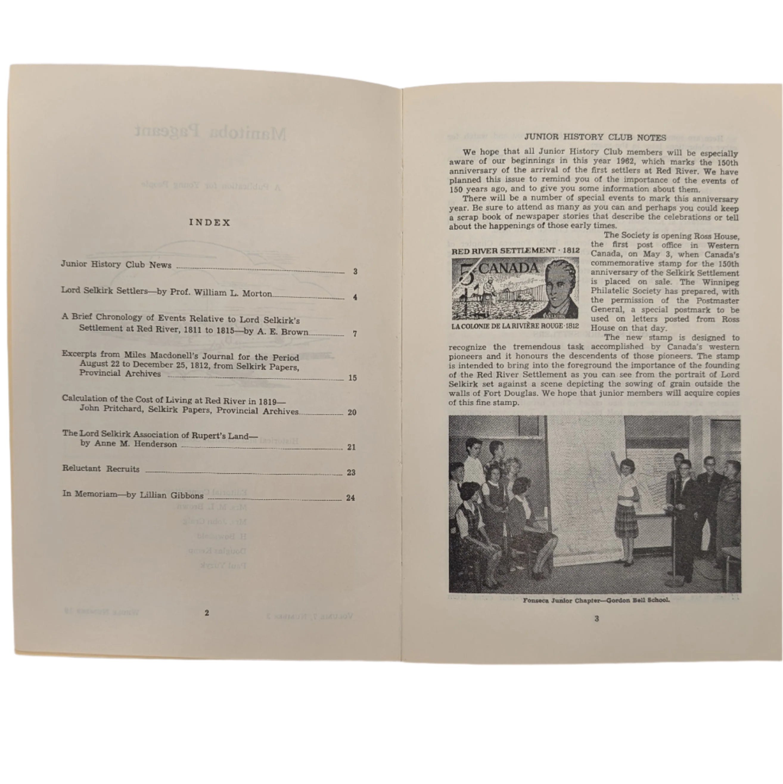 Open book with text and images on a white surface